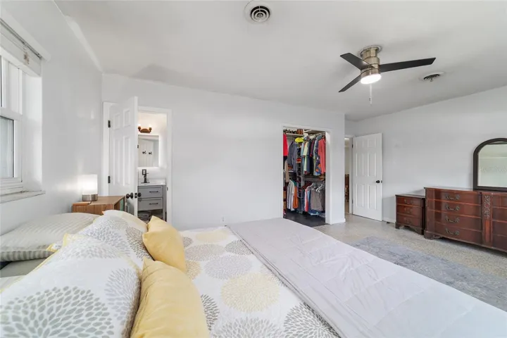 Primary Bedroom with Terrazo Floors and Walk-In Closet