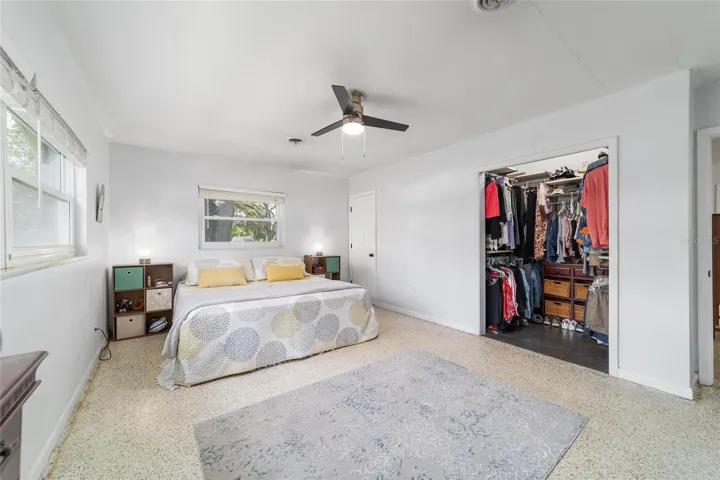 Primary Bedroom with Terrazo Floors and Walk-In Closet