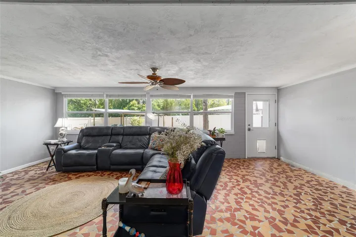 Family Room with Broken Mosaic Tile and Newer Windows