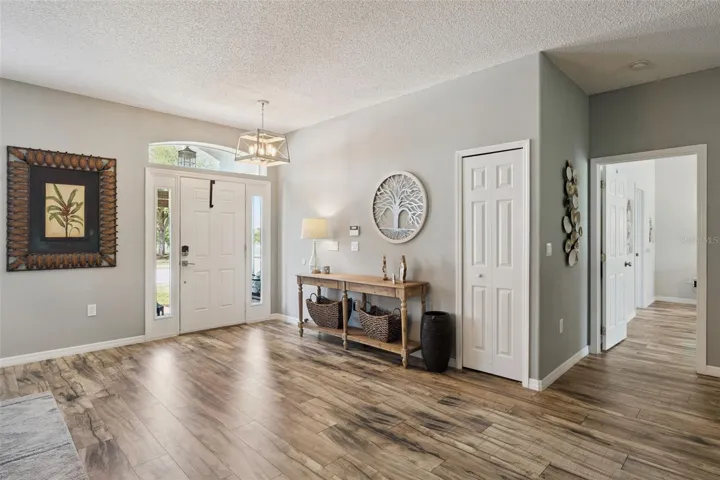 Lovely foyer with transom window, smart lock entry and coat closet