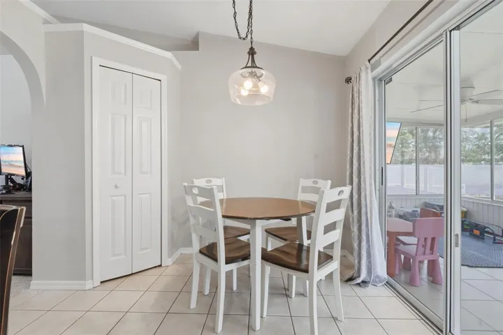 Eat-in kitchen area with sliding glass doors leading to enclosed porch