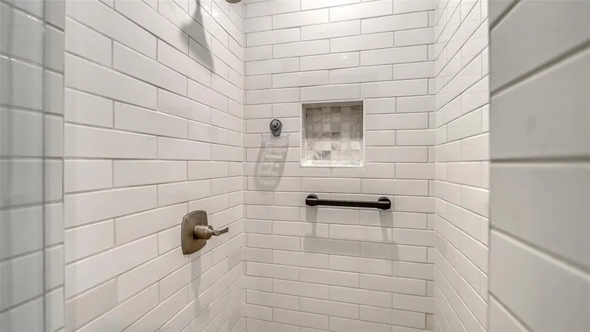 Guest bathroom tiled shower.