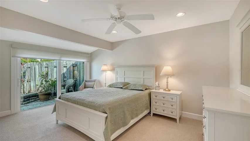 Guest bedroom with floor to ceiling sliders opening to the patio.