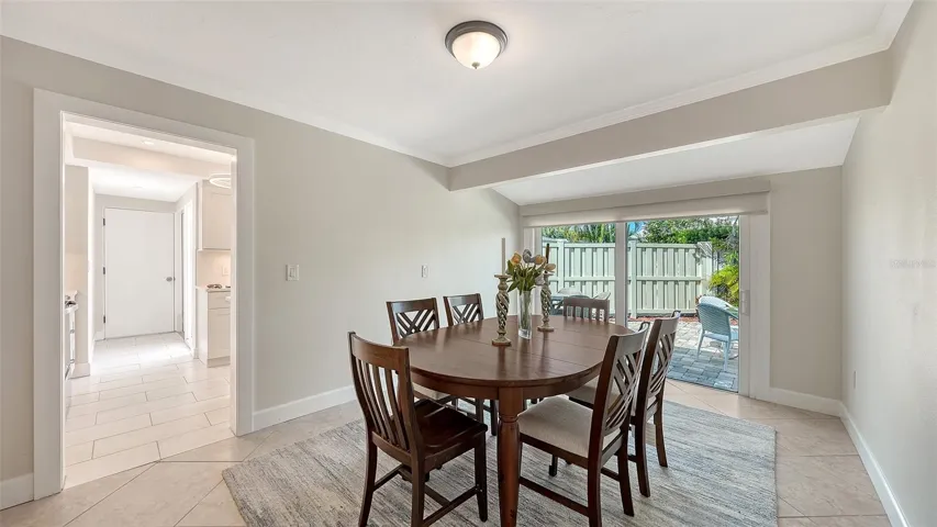 Dining room with floor to ceiling sliders opening to the private patio.