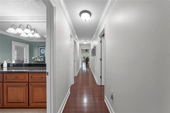 Hallway to bedrooms and bonus room. Pool bath on the left.