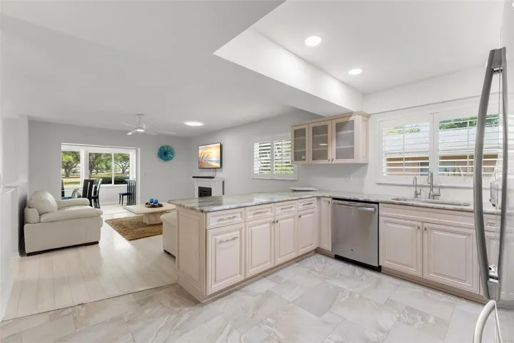 KITCHEN LOOKING OUT TO FAMILY TV ROOM AND BACK PORCH. VIEW OF FAIRWAY IN EVERY ROOM