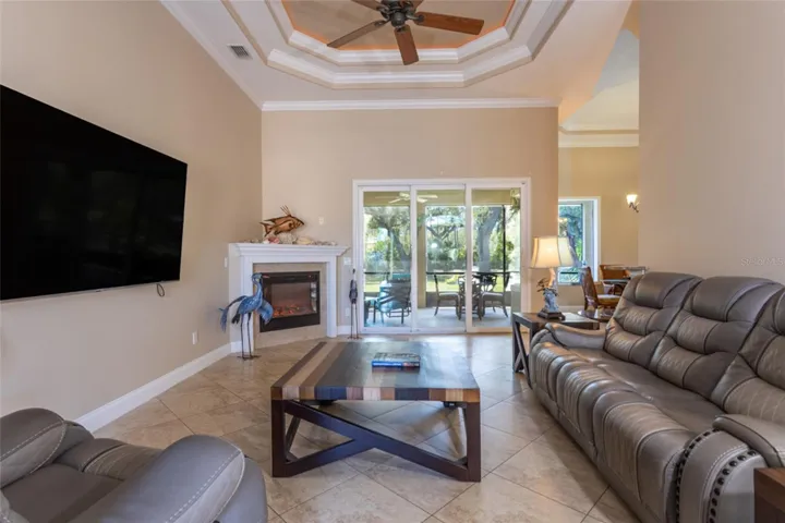 Living room with triple slider & multi tray ceiling with ambient lighting