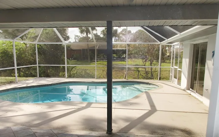 covered lanai leads out to pool