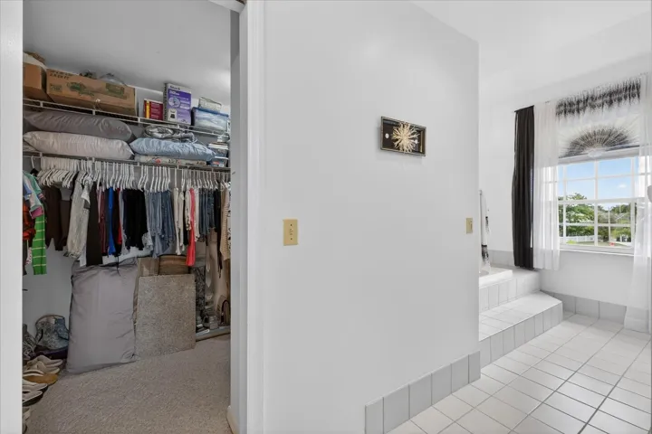 Large walk in closet with laudry chute to lower level laundry room.