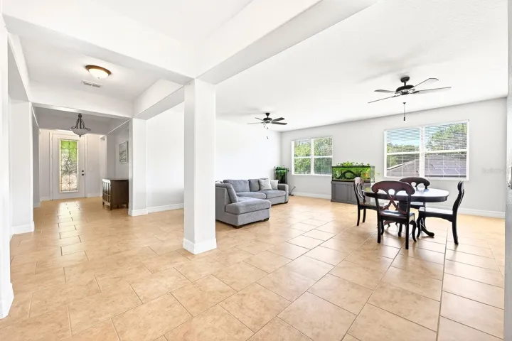 Inside, the home features a bright, OPEN CONCEPT floor plan with a seamless flow between formal living and dining spaces and a comfortable family room – ideal for both everyday living with family and entertaining friends.