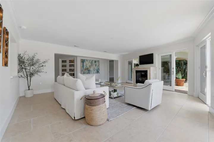 Living room with gas fireplace and sliders to pool