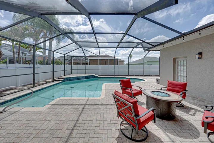 Expansive outdoor living with a large lanai, pool, and lounge area, all set in a low-maintenance backyard designed for effortless Florida living and entertaining.