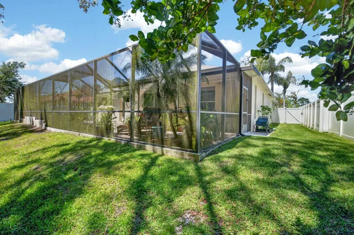 Back yard facing screened in pool