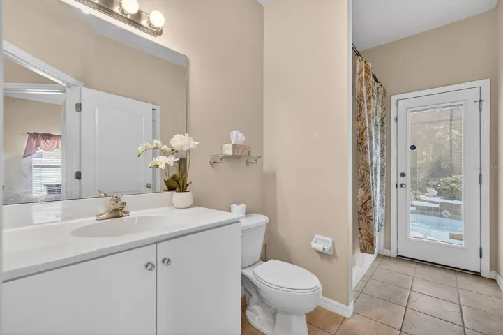 Guest Bathroom/on side with 2 bedrooms and door to pool lanai