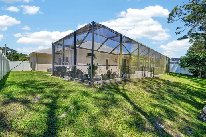 Back yard facing screened in pool