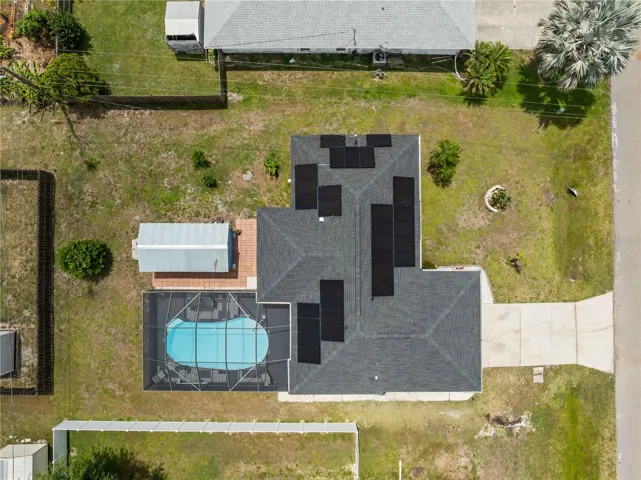 Aerial showcasing pool, solar and shed