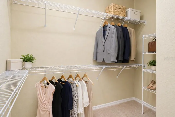 Virtually staged photo for primary bedroom's walk in closet