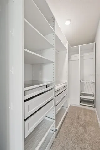 So much space in this oversized walk-in closet. Drawers have jewelry storage and so much more!