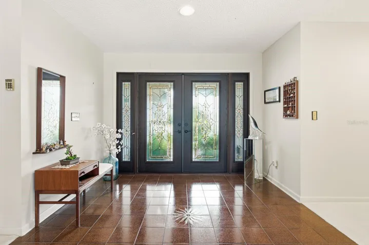 Double entry full glass doors with sidelights to maximize the light
