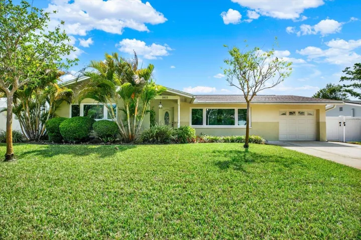 Gorgeous meticulously manicured front yard welcomes you home