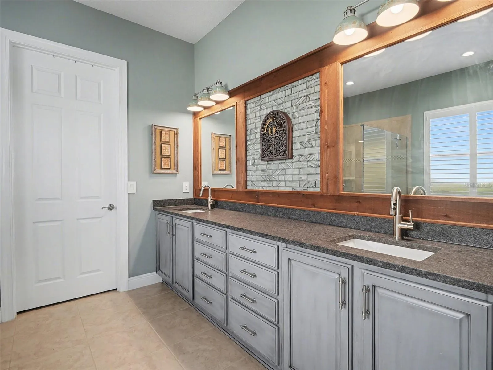 Luxurious primary bedroom with tray ceiling detail, generous natural light, and a peaceful retreat feel.