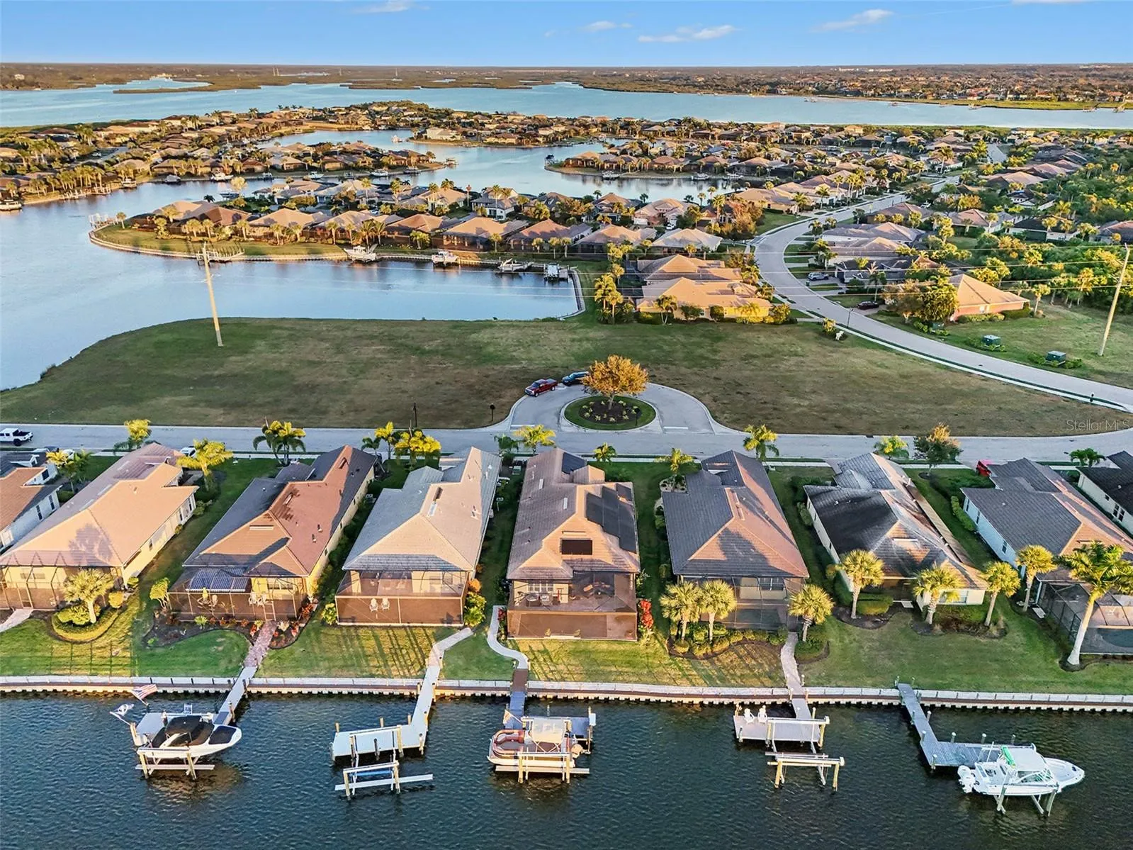 Aerial view of the waterfront property showcasing private dockage, surrounding waterways, and the neighborhood setting.