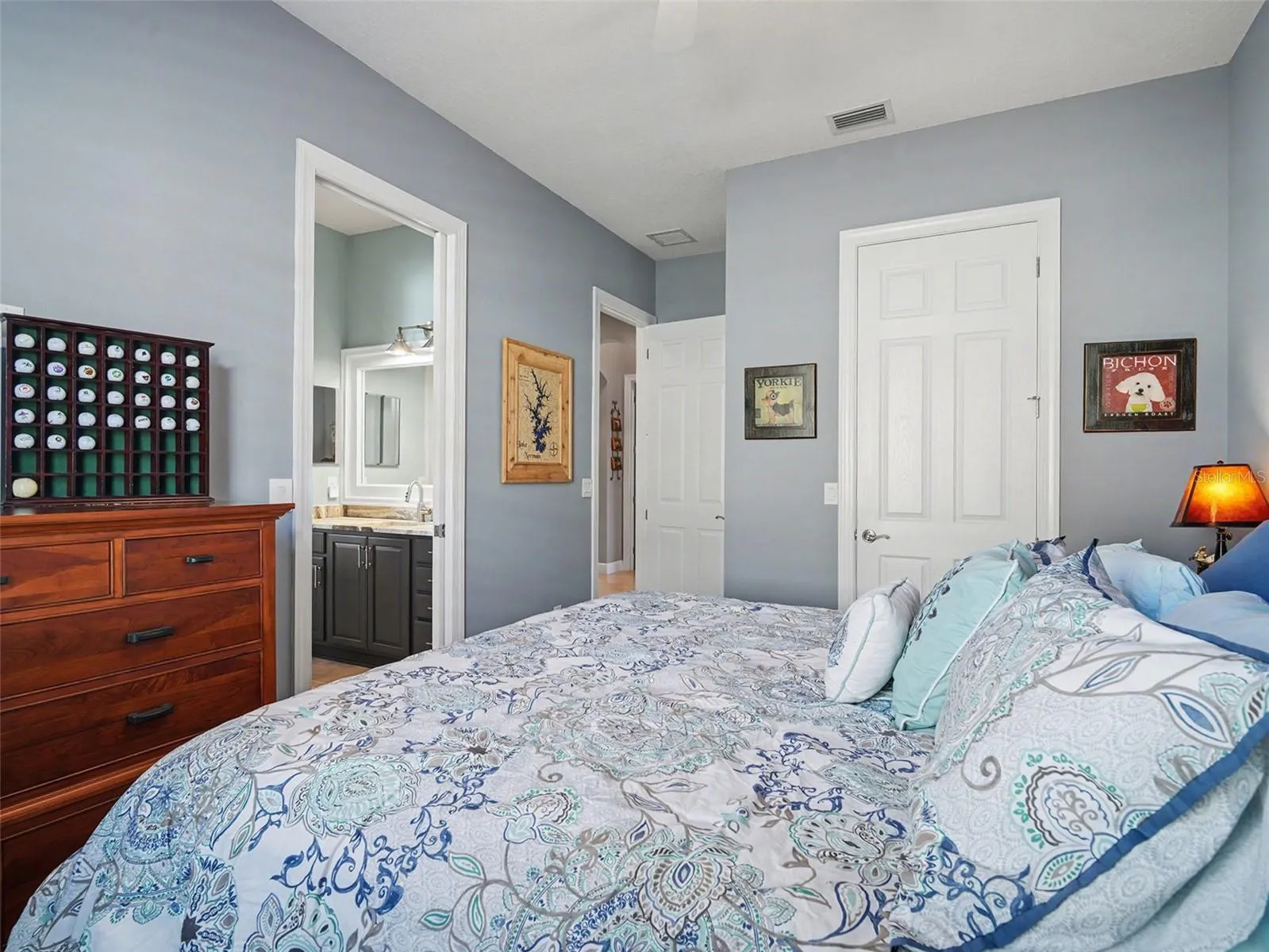 Additional guest bedroom with ceiling fan, generous space, and a light, airy feel.