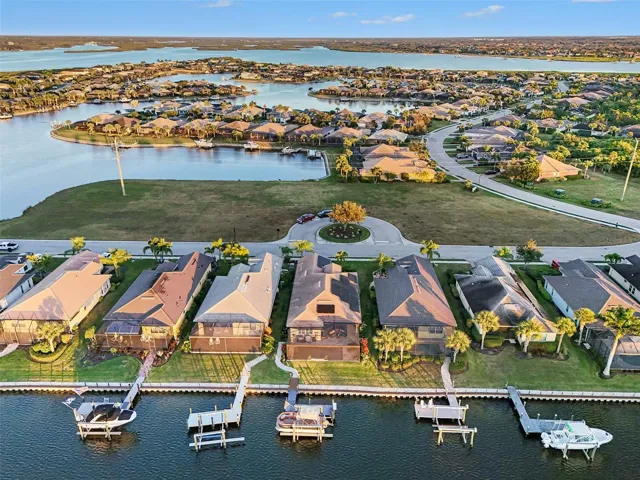 Aerial view of the waterfront property showcasing private dockage, surrounding waterways, and the neighborhood setting.