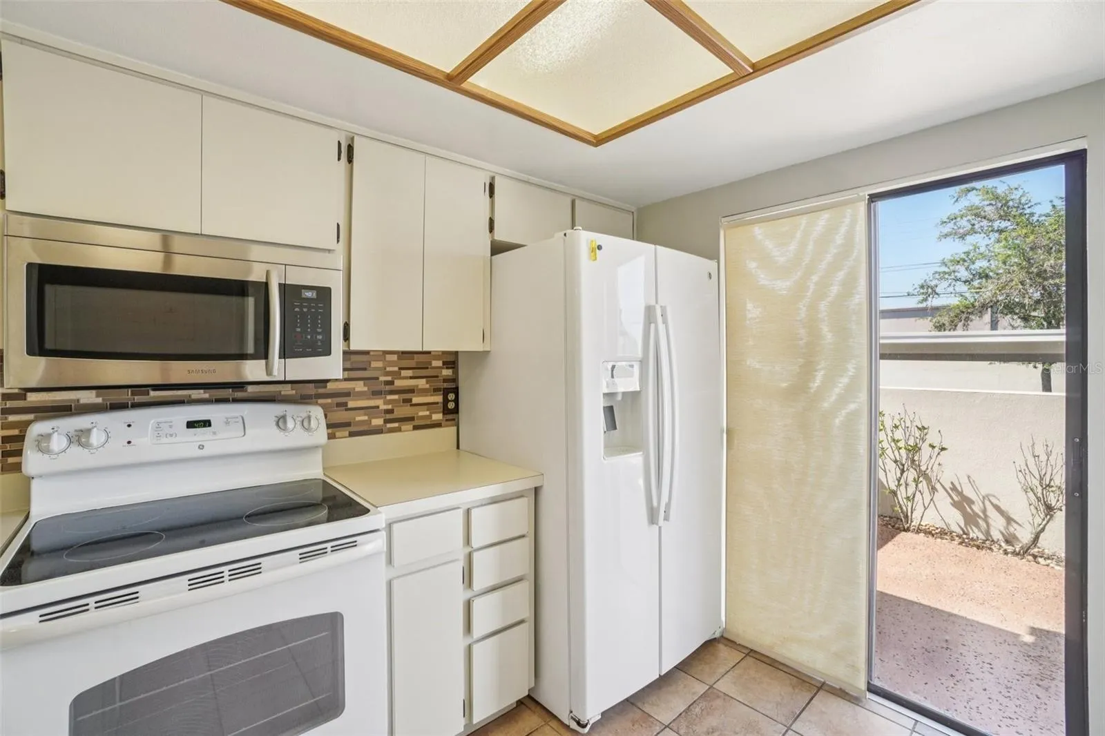 WELL LIT KITCHEN OVERLOOKS THE FRONT COURT YARD