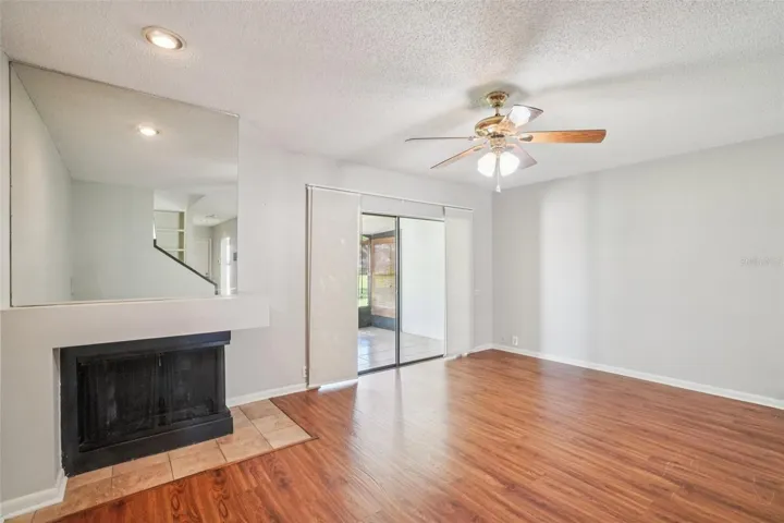 LIVING ROOM/DINING ROOM COMBO HAS CORNER WOOD BURNING FIREPLACE