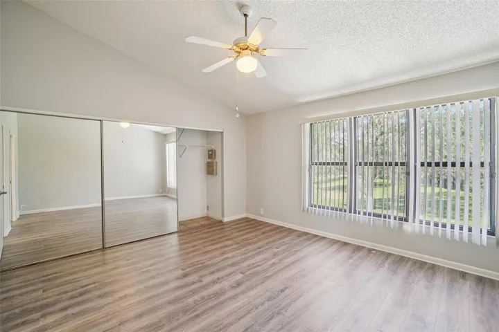 SPACIOUS PRIMARY BEDROOM OVERLOOKS BACK YARD! AND NO CARPET!