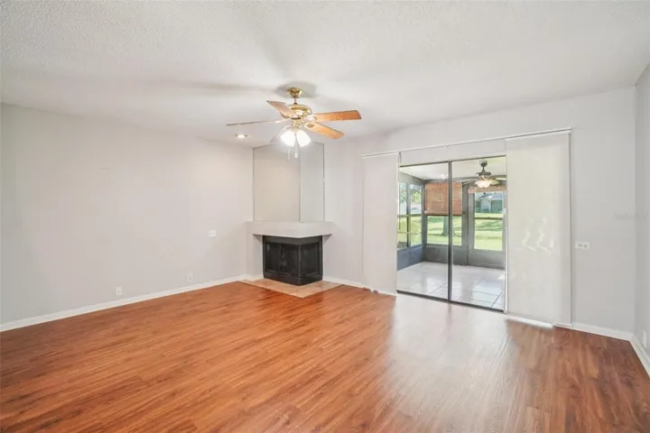 LIVING ROOM/DINING ROOM COMBO HAS CORNER WOOD BURNING FIREPLACE