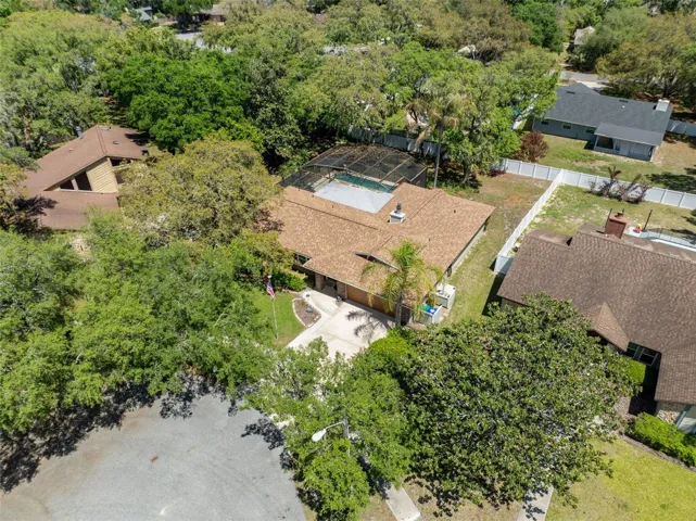 Another aerial view of home, driveway and pool cafe