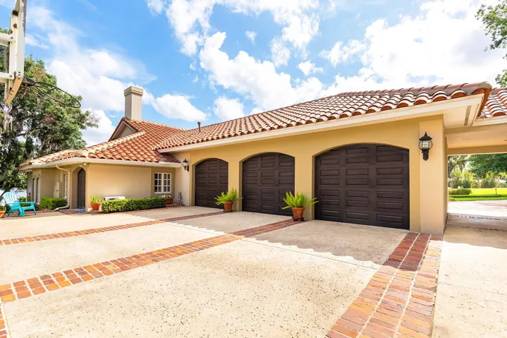 Side rear 3 car garage with plenty of storage space and parking.