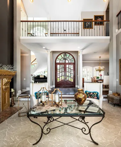 View from the back lake view into the living room. Notice the walkway above that leads to the loft and additional bed and bath.