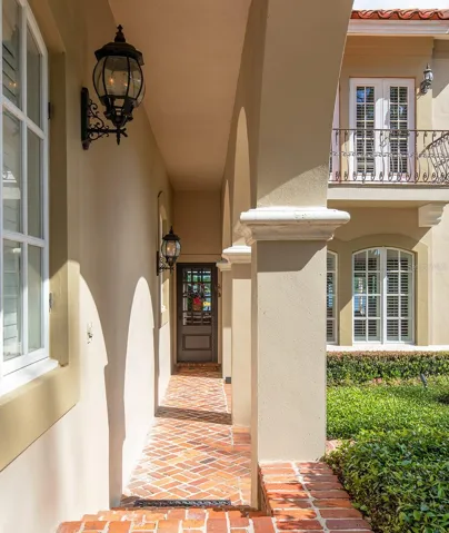 Covered walkway from the Porte -Cochere directly into another entrance to the home.