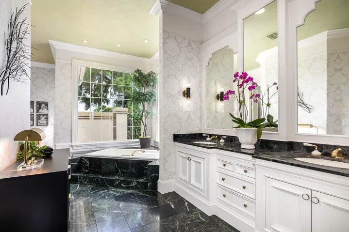 Dual sink cabinets, MARBLE counters and soaking garden tub with plenty of room for dressing.