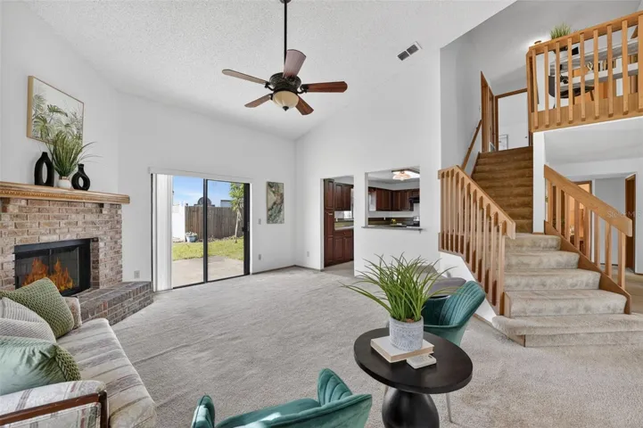 The open and bright Great Room/Family Room is adjacent to the Kitchen and features a beautiful wood-burning fireplace with brick surround