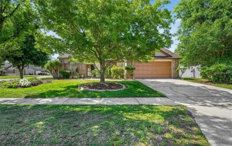 Tree-lined extended driveway makes this home so picturesque
