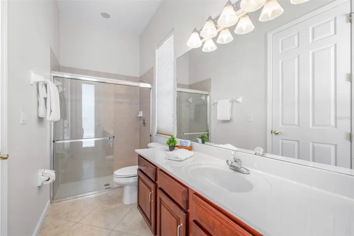 Third full bathroom with oversized vanity and convenient guest access