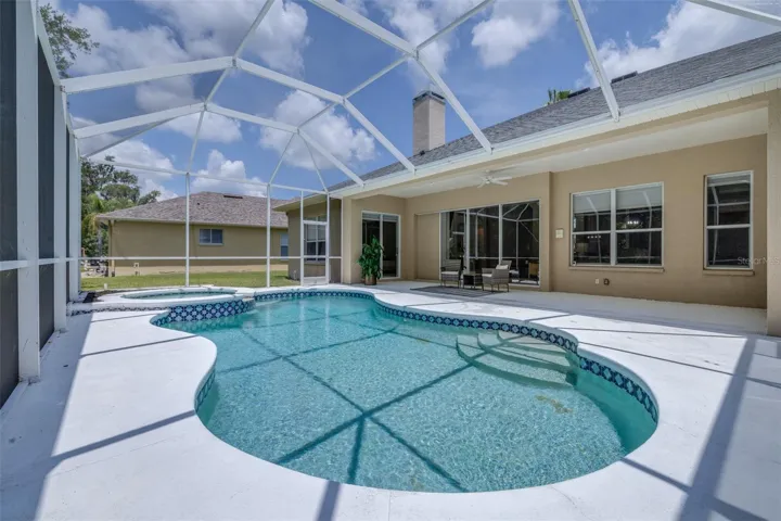 Screened pool/spa area overlooks conservation behind the home