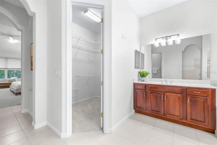 Expansive primary bathroom layout with separate vanities and spa-like atmosphere