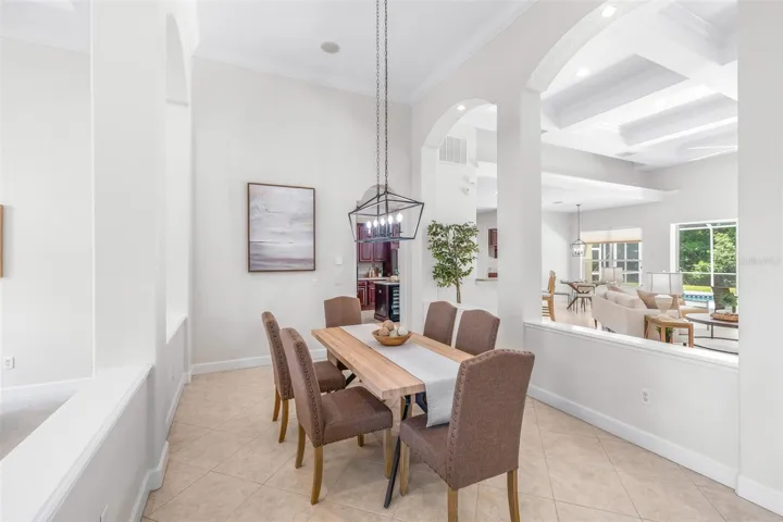 Spacious dining area overlooking the great room with soaring ceilings and abundant natural light