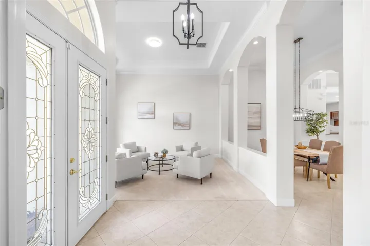 Grand foyer with high ceilings and natural light