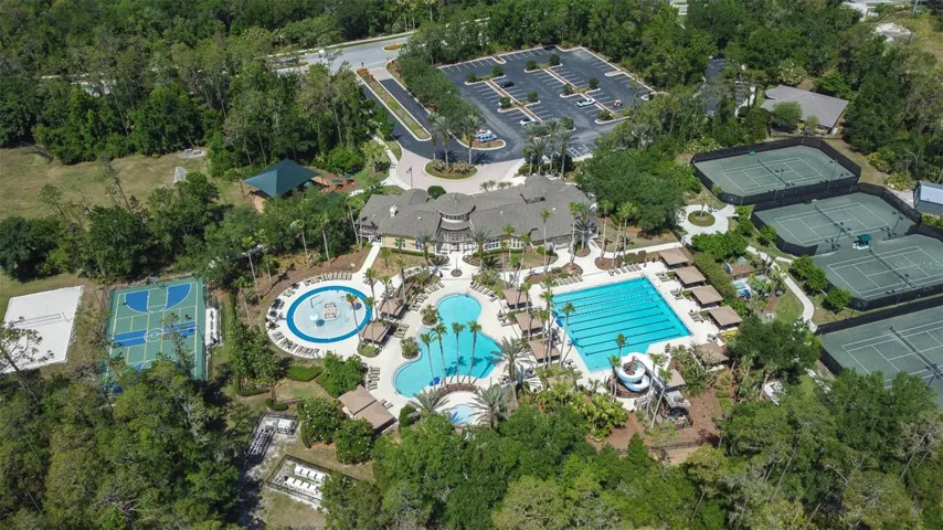 Amenities include tennis, splash pool, family pool, lap pool with slide, sand volleyball, basketball/pickleball courts, soccer field, playground, and clubhouse with cafe, locker rooms, gym, movie theater and large gathering room that can be rented for events.
