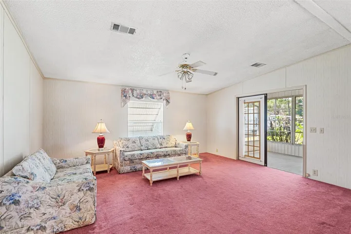 SPACIOUS LIVING ROOM. FRENCH DOOR LEADS TO ENCLOSED PORCH