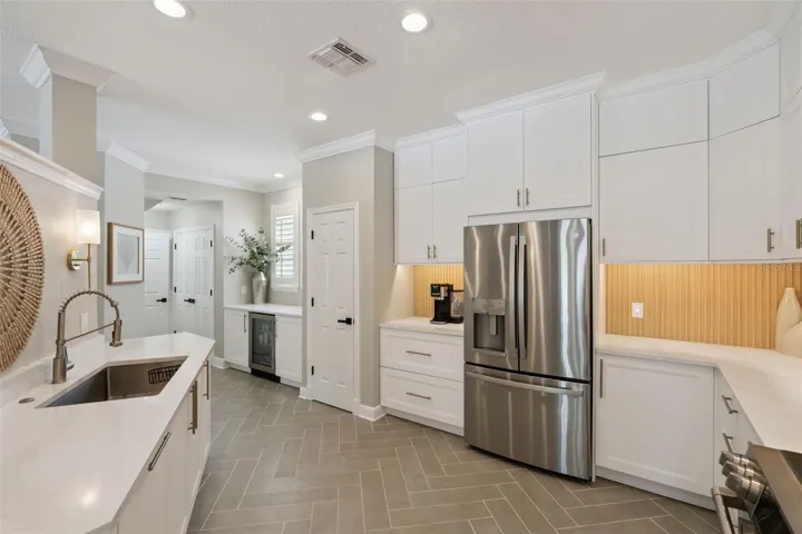Kitchen showcases beautifully lit backsplash.  Two pantries afford ample storage.