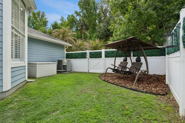 Private yard with conservation land in background.