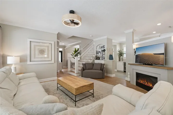 Family room with new built-in cabinet and electric fireplace.