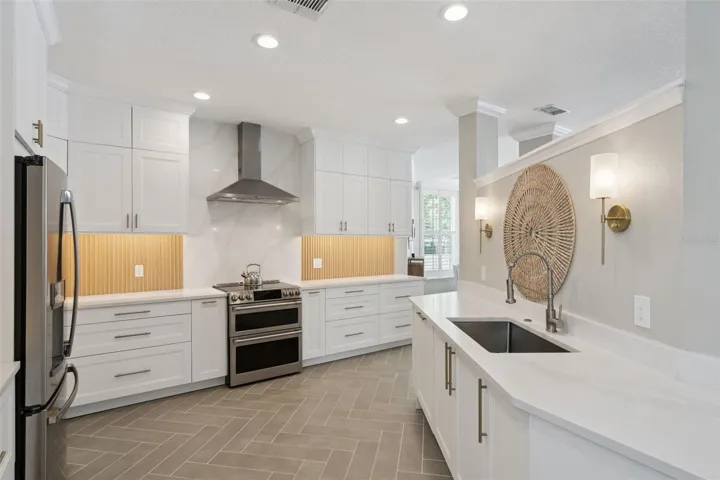 Remodeled kitchen with quartz countertops and induction stovetop.